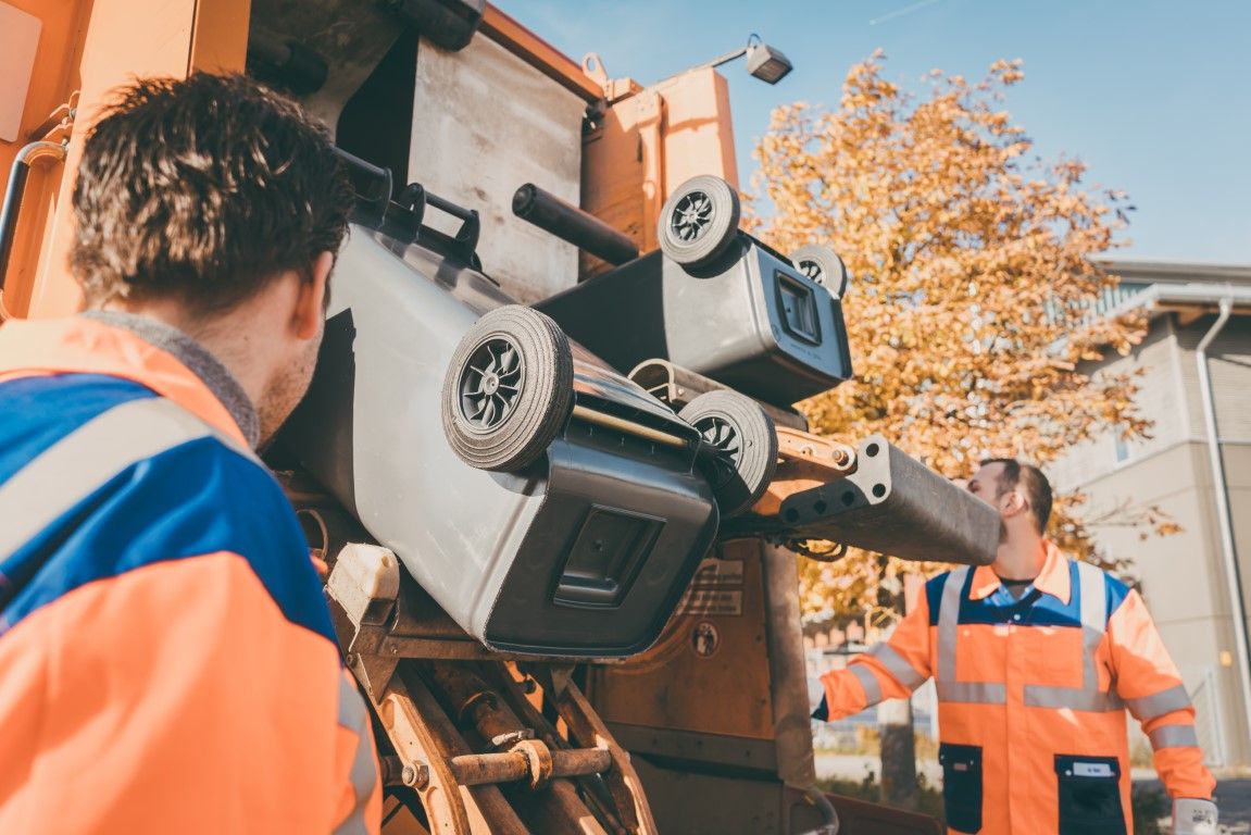 Junk removal crew member loading debris into a truck
