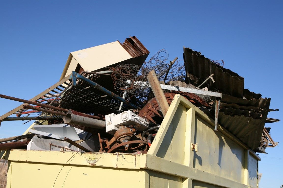 Junk removal truck parked outside a residential home