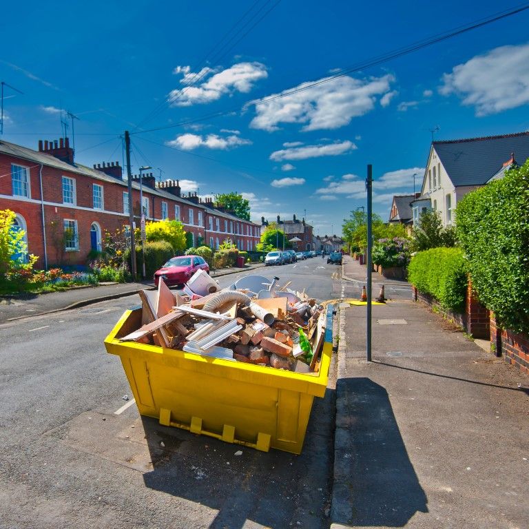 Movers carrying a couch out of a residential home
