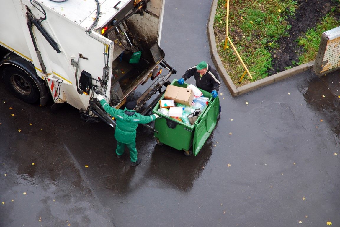 Junk removal team clearing debris from a residential garage